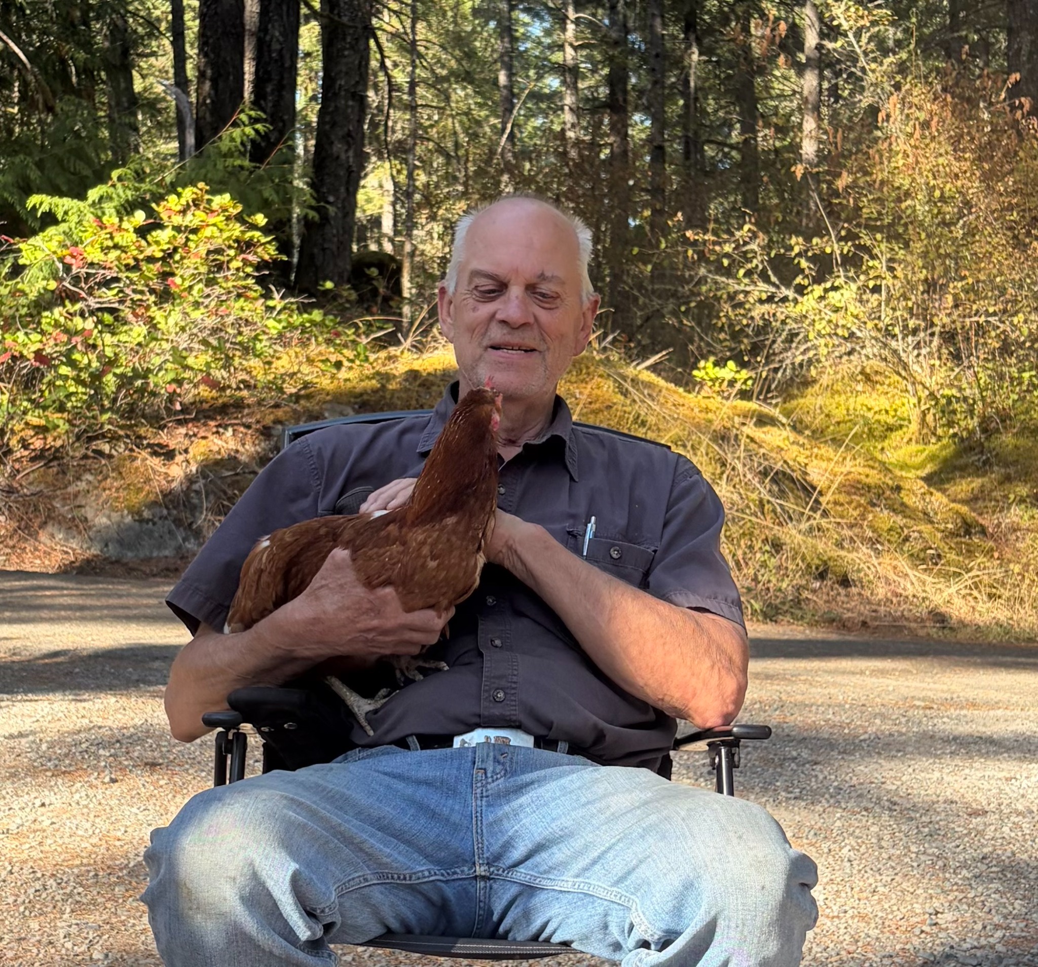 Rob outdoors holding a chicken